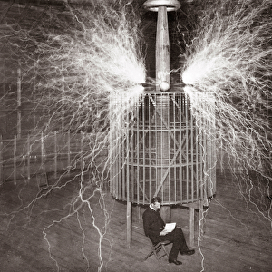 Nikola Tesla sitting in his Colorado Springs laboratory with his "