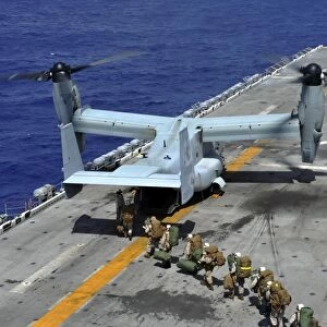 Marines board an MV-22 Osprey on the flight deck of USS Bonhomme Richard