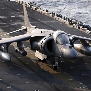Sailors prepare an AV-8B Harrier jet aircraft for take-off from USS Essex