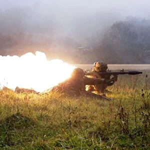 Soldiers fire a rocket propelled grenade at opposing forces