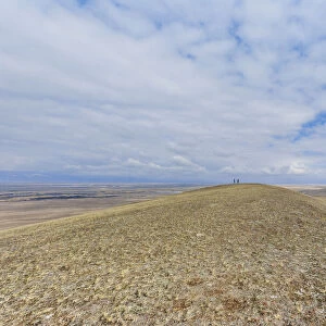 Two people walking in vast landscape with dry grass Barguzin Valley, Buryatial, Siberia