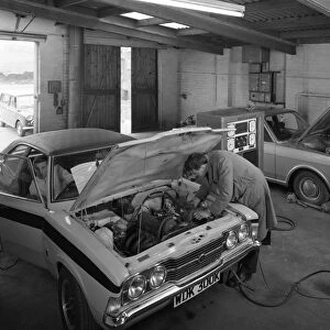 Cortina Mk 2 and Mk3 GT in a garage being serviced / modified, 1972