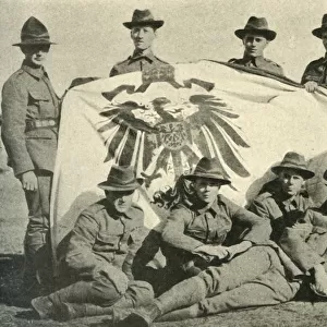 New Zealand soldiers with captured German flag, First World War, 1914, (c1920). Creator: Unknown