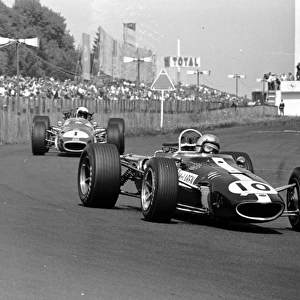 1967 GERMAN GP - NURBURGRING: Bruce McLaren leads World Champion Jack Brabham at the Nurburgring. Brabham finished 2nd behind Denny Hulme