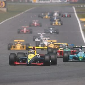 1990 British Grand Prix: Aguri Suzuki heads into Stowe with Ivan Capelli, Nelson Piquet, Eric Bernard and the rest of the field following down
