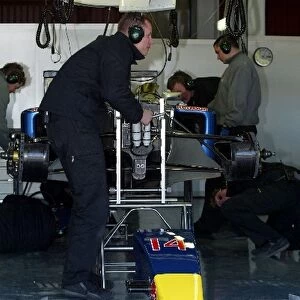 Formula One Testing: Red Bull mechanics work on the car of David Coulthard Red Bull Racing RB01