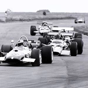 Silverstone, Great Britain. 19 July 1969: Piers Courage, Brabham BT26-Ford, 5th position, leads Graham Hill, Lotus 49B-Ford, 7th position, and Chris Amon