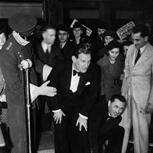 Actor Will Hay has his feet set in concrete on arrival for a personnal appearence at