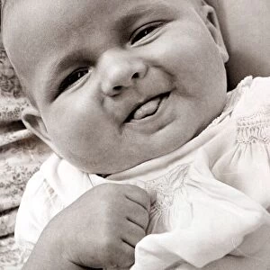 Baby sticking its tongue out, circa 1950
