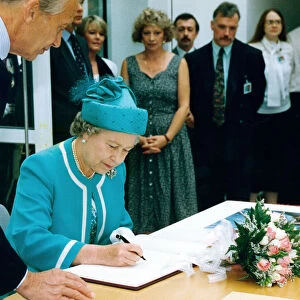 Queen Elizabeth II signs the visitors book at the British Council Offices, Manchester