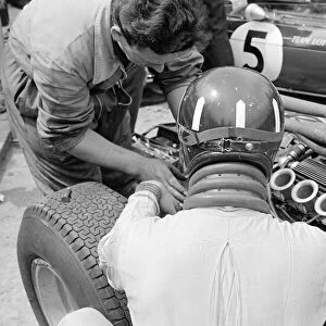 Silverstone Practice Day- Graham Hill in the pits with his BRM mechanic. July 1965