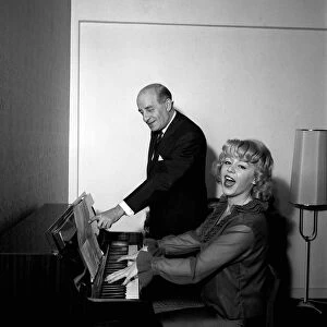 Singer Kathy Kirby playing the piano with her mentor band leader Bert Ambrose