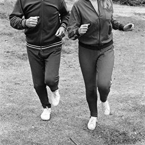 Television personality Nicholas Parsons jogging with his daughter. September 1976
