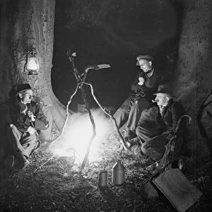 Tramps at night by a camp fire Circa 1930
