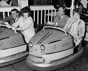 Racing drivers Graham Hill and Jim Clark enjoying a dodgem ride